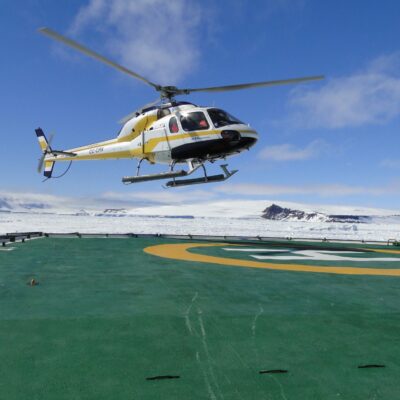 Flying over the Antarctic in an helicopter during the cruise adventure